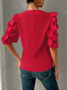 Detailed back view of a red women's blouse with sheer 3D polka dot bubble sleeves.