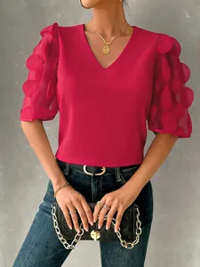 Detail view of a stylish red V-neck blouse with 3D hollow dot sheer puff sleeves for summer.