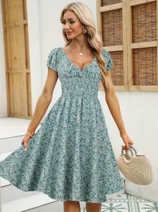 Detail of retro floral puff sleeve V-neck dress with smocked waist and delicate floral print