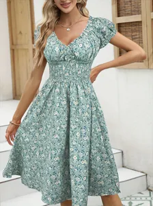 Detailed view of French vintage floral midi dress with smocked waist and puff sleeves