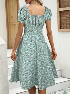 Back view of a French vintage floral dress with puff sleeves and shirred waist detailing.