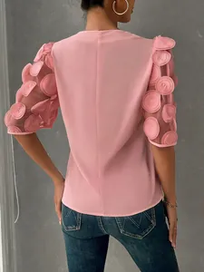 Rear view of pink blouse featuring elegant 3D floral mesh puff sleeves and casual design.