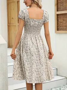 Detailed back view of a French vintage floral dress featuring puff sleeves and a smocked waist.