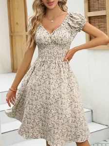Detailed view of vintage French floral puff sleeve V-neck dress with smocked waist
