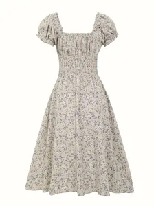 Detailed view of the vintage floral print and smocked waist on this puff sleeve dress.
