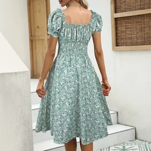 Elegant French vintage floral puff sleeve midi dress shown from the back view on a woman