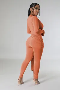 Side view of a slim-fit orange long-sleeved bodysuit with ruched detailing on the hip