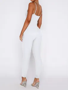Back view detail of a chic white ribbed knit bodycon jumpsuit with backless spaghetti straps