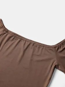 Detailed close-up of a vintage brown off-the-shoulder tight fitting T-shirt neckline.