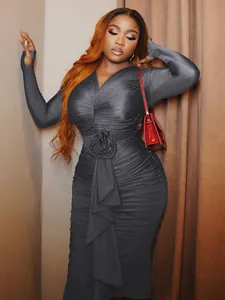 Detail of elegant charcoal long-sleeve ruched bodycon dress with 3D rose waist decoration.