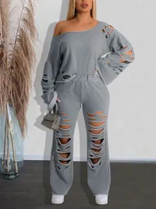 Detailed look at grey ripped two-piece sports set featuring an off-the-shoulder sweatshirt