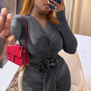 Detailed view of grey long-sleeved V-neck dress featuring a 3D rose waist design