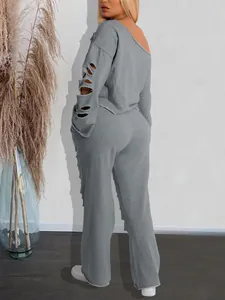 Detailed back view of grey ripped tracksuit with off-shoulder sweatshirt and loose pants