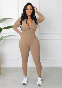 Full body shot of a khaki ribbed long-sleeve athletic jumpsuit with front zipper
