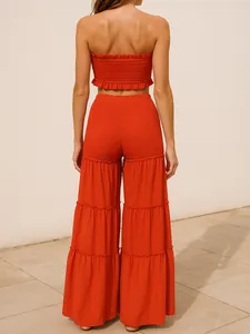 Vista posterior detallada de un conjunto naranja rojizo con top palabra de honor y volantes