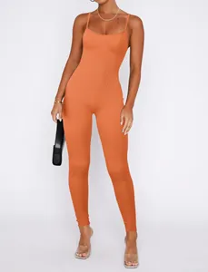 Slim fit orange ribbed jumpsuit with spaghetti straps and long pants for casual wear.