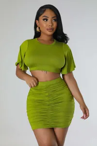 Detail view of olive green two-piece set featuring ruffled crop top and ruched skirt