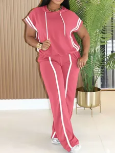 Full-length view of a rose pink two-piece hooded sporty set with white stripe accents