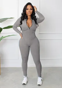 Detailed view of the ribbed fabric and front zipper on this grey slim-fit jumpsuit.