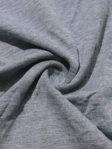 Macro detail view of soft grey melange knitted fabric texture for a sports tracksuit set