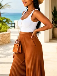 Close-up showing the pleated texture of these high waist wide-leg pants in brown.