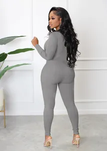 Detailed back view of a grey ribbed long sleeve athletic jumpsuit for women's fitness.