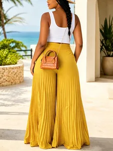Back view of high-waisted yellow pleated wide-leg trousers for summer vacation