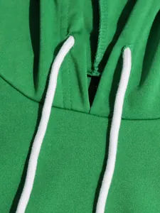 Detailed macro view of green hooded sweatshirt neckline and white cotton drawstrings
