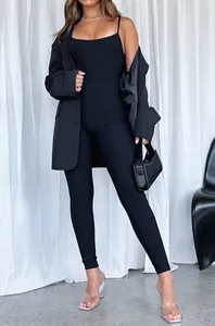 Full body view of a sleek black tight-fitting long jumpsuit with thin spaghetti straps