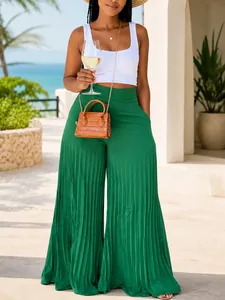 Detail of high-waisted green pleated wide-leg pants for a summer vacation look