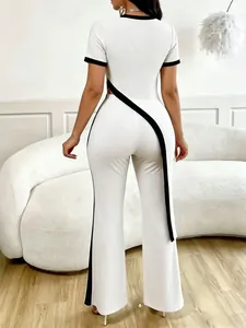 Fashionable two-piece white ribbed knit set with asymmetrical black trim and wide-leg pants