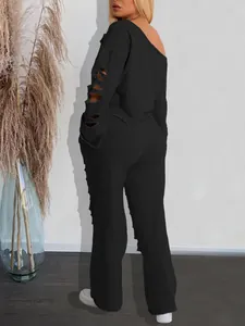 Detailed back view of a black two-piece tracksuit with ripped sleeves and pants