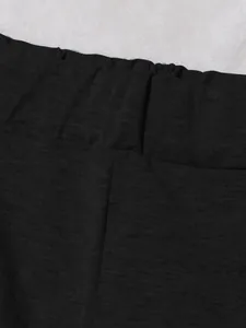 Detailed macro view of the black elastic waistband on these sporty knitted loungewear pants.
