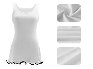 Close-up of white ribbed fabric texture and contrast wavy hem detail on a slim tank dress.