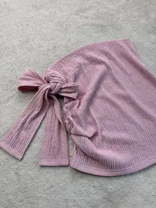 Dettaglio del tessuto strutturato rosa con fiocco elegante per set da vacanza