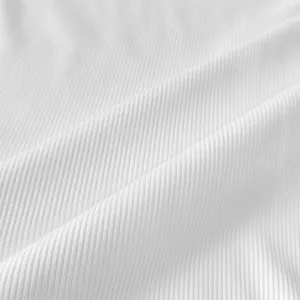 Macro view of white ribbed fabric texture showing soft vertical stripes and elastic material