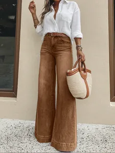 Detail view of women's vintage washed brown wide-leg denim jeans with high-waisted fit