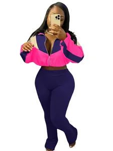 Trendy two-piece color block athletic set with pink zip-up jacket and navy leggings