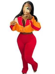A full view of women's color-block sport set featuring a zipper jacket and red leggings