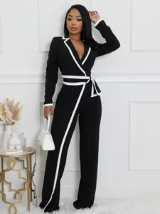 Elegante mono bicolor negro y blanco de manga larga con cinturón ajustable para mujer