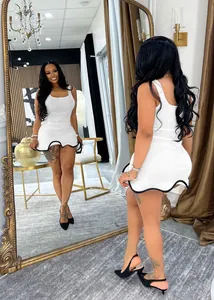 Close-up of white sleeveless bodycon dress featuring black contrast wave hem design