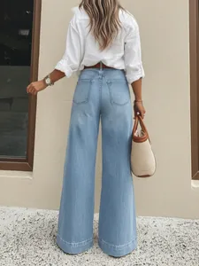 Back view of woman wearing vintage washed light blue wide-leg jeans in a stylish outfit