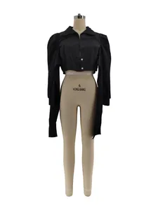 Close-up detail of black puff shoulder cropped blouse with long trailing sleeves