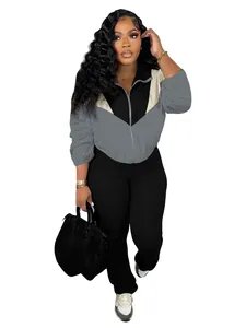 Detail view of stylish women's colorblock zipper jacket and leggings sport set