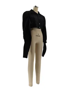 Side view of black cropped shirt featuring dramatic padded shoulders and long sleeves