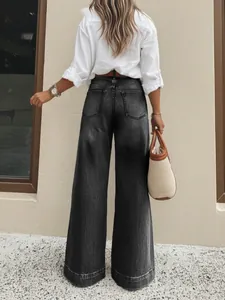 Detailed back view of stylish women's vintage washed charcoal grey wide-leg denim jeans