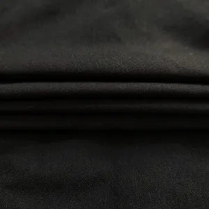 Close-up macro view of premium black woven fabric texture showing detailed thread weave