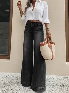 Classic women's vintage washed black wide-leg denim jeans showing relaxed fit.