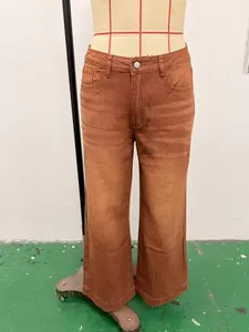 Detailed shot of retro brown washed wide-leg jeans on mannequin for vintage fashion looks