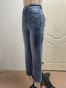 Detailed side view of slim fit stretch denim jeans with embroidery on a mannequin